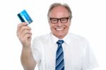 Cheerful Aged Employer Holding Up A Cash Card Stock Photo