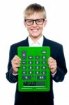 Young boy Holding Calculator Upside Stock Photo