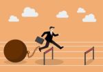 Businessman Jumping Over Hurdle With The Weight Stock Photo