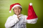 Girl Holding Santa Claus Hat Stock Photo