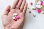 Top View Of The Pills On The Hand And White Background, A Hand Hold The Pills And Drug Stock Photo