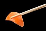 Chopsticks With Sliced Raw Salmon Stock Photo