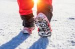 View Of Walking On Snow With Snow Shoes And Shoe Spikes In Winte Stock Photo