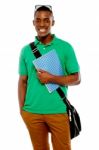 African Male Holding Book And Bag Stock Photo