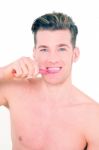 Young Man Brushing His Teeth Stock Photo