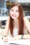 Portrait Of Thai Adult Beautiful Girl Write A Book And Smile In University Stock Photo