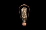 Incandescent Light Bulb On Black Background Stock Photo