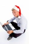 Handsome Man With Christmas Hat And Laptop Stock Photo