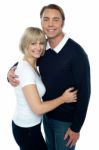 Stylish Man In Pullover Embracing His Blonde Wife Stock Photo