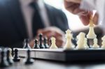 Confident Businessman Colleagues Playing Chess With Colleague To Stock Photo