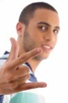 Young Guy Showing Rock Hand Gesture Stock Photo