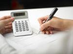 Bookkeeping With Calculator Stock Photo