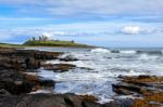 View Of Dunstanburgh Castle At Craster Northumberland Stock Photo