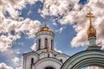 Dome Of A Temple Against A Blue Cloudy Sky Stock Photo