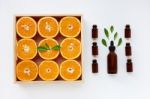 Bottle Of Essential Oil From Oranges Citrus Fruit With Fresh Ora Stock Photo