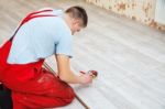 Handyman Laying Down Laminate Flooring Boards Stock Photo