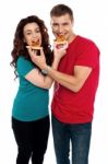 Smiling Young Couple Sharing Pizza Stock Photo