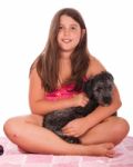 Girl In Swimsuit At The Beach With Dog Stock Photo