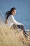 Portrait Of Asian Teenager Relaxing On Natural Field Stock Photo