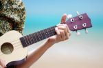 female Hand Playing Ukulele Stock Photo