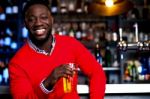 African Guy Posing With Chilled Beer Stock Photo