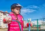 Little Girl In A Safety Helmet Riding A Bicycle Stock Photo