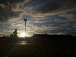 Silhouette  Running On Road At Sunrise Stock Photo