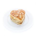 Pile Of Heart Shaped Pancakes On White Plate Stock Photo