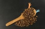 Coffee Bean In Wooden Spoon With Two Colorful Hands Stock Photo