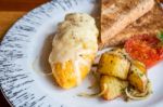 Omelet With Potato, Tomatoes Parsley And Feta Cheese And Bread In White Plate On Wooden Table Stock Photo