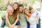 Garandparents Giving Piggyback Ride Stock Photo