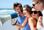 Teenagers Shouting Through Megaphone Stock Photo