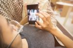 Woman Holding And Using Smartphone At Room Stock Photo