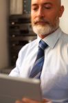 Businessman Middle-aged Working From Home With A Tablet Stock Photo