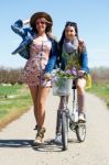 Two Beautiful Young Women With A Vintage Bike In The Field Stock Photo