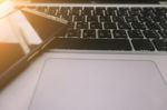 Laptop On The Desk With Mobile Phone Stock Photo