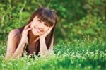 Woman Laying On Grass Stock Photo