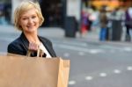 Cheerful Business Woman Holding Shopping Bag Stock Photo