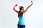 Beautiful Girl Dancing And Listening To Music. Isolated On White Stock Photo