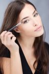 Woman Applying Make Up Stock Photo