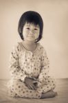 Little Asian (thai) Girl Sitting. Vintage And Retro Picture Styl Stock Photo