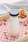 Almond Milk In Bottle With Almonds On Wood Tray Stock Photo