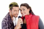 Young Male And Female Singer With Microphone Stock Photo