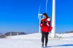 Young Woman Is A Happiness With Camera In Winter Of Sky And Winter Road With Snow And Red Dress Stock Photo