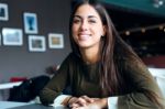 Beautiful Girl Drinking Coffee Sitting Indoor In Urban Cafe Stock Photo