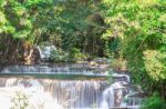 The Water Flowing Over Rocks And Trees Down A Waterfall At Huay Mae Khamin Waterfall National Park ,kanchana Buri In Thailand Stock Photo