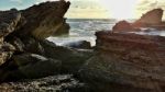 Sunset In The Bay With Rocks Stock Photo