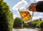 Female Hand Holding A Mug Of Beer Stock Photo