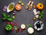 The Ingredients For Homemade Pizza On Dark Stone Background Stock Photo