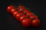 Organic Fresh Cherry Tomatoes On Black Board Background Stock Photo